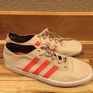 Tan adidas with orange stripes. Never been worn.